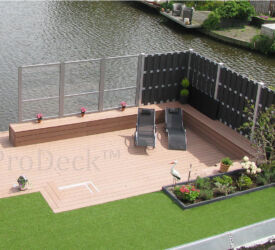 Wat een prachtige tuin met mooie antracieten luxe schuttingen gecombineerd met een naturelbruine vlonder.